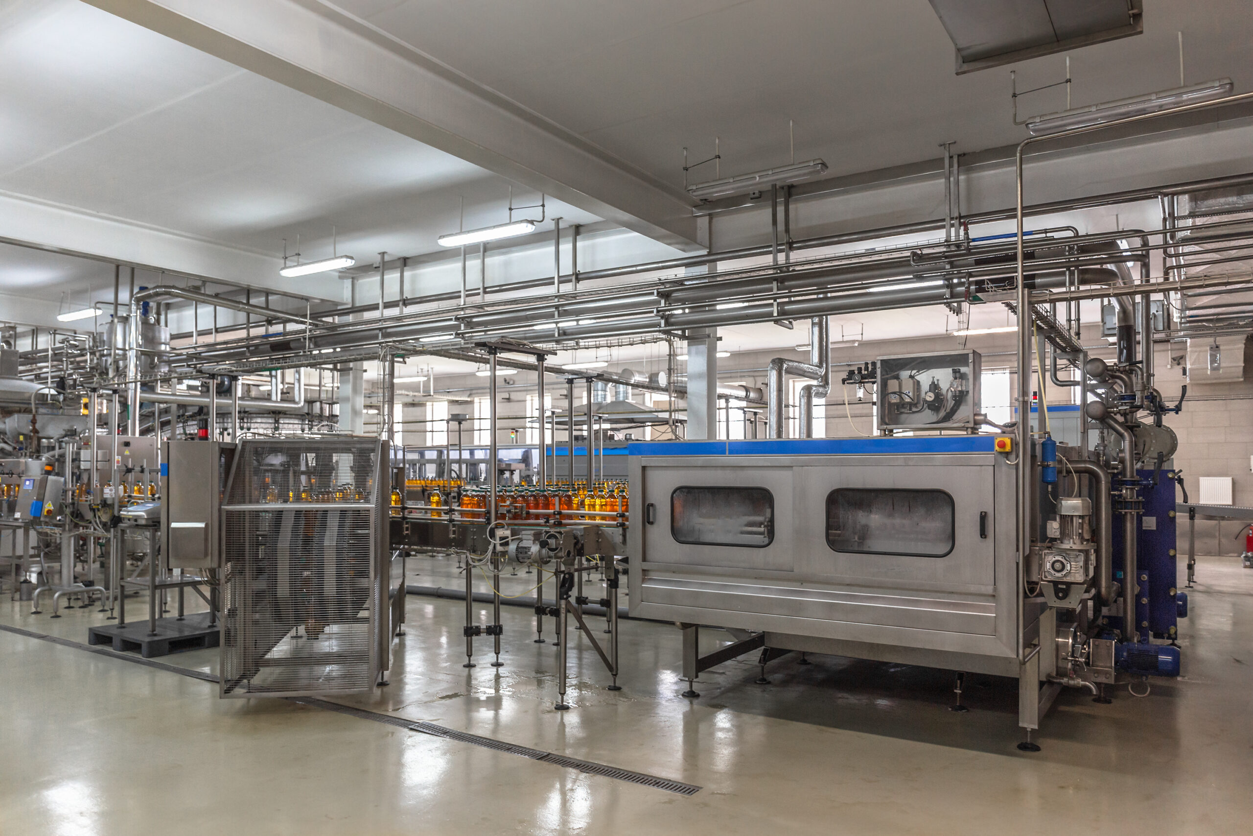 Automatic conveyor belt of production line of juice on beverage plant or factory, modern computerized industrial equipment.